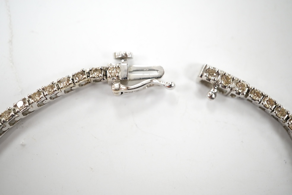 A modern 9ct white metal and diamond set tennis bracelet, with a total diamond weight of 1.50ct, 17.3cm, gross weight 6.6 grams. Condition - good